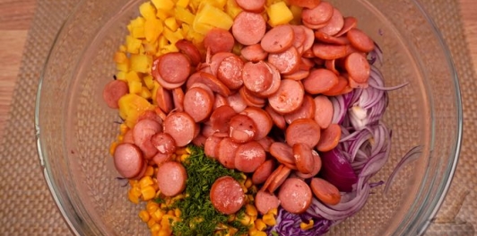 Фото приготовления рецепта: Салат с картошкой, капустой, кукурузой и сосисками - шаг №13