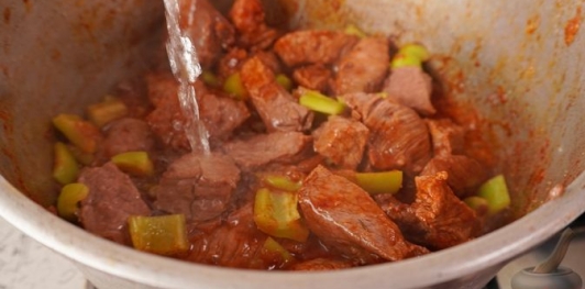 Фото приготовления рецепта: Пёркёльт из говядины, со сладким перцем, помидорами и луком - шаг №12