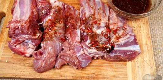 Фото приготовления рецепта: Бараньи рёбрышки, запечённые с помидорами и перцем под острым соусом - шаг №14