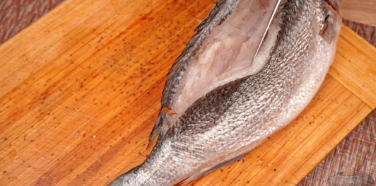 Фото приготовления рецепта: Фаршированная дорада с изюмом и орехами, запечённая со сладким перцем - шаг №4