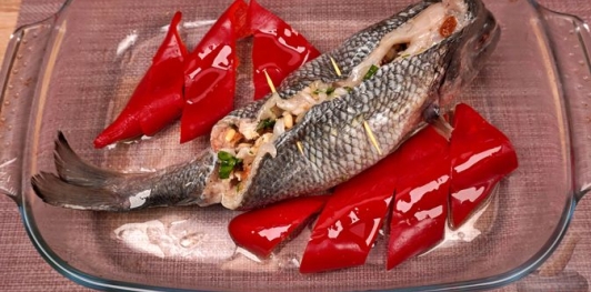 Фото приготовления рецепта: Фаршированная дорада с изюмом и орехами, запечённая со сладким перцем - шаг №19