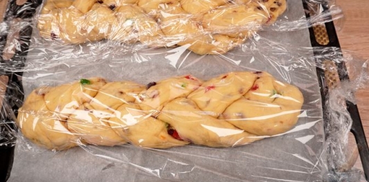 Фото приготовления рецепта: Куличи-косички с изюмом, цукатами, цедрой лимона и глазурью с лепестками миндаля - шаг №27