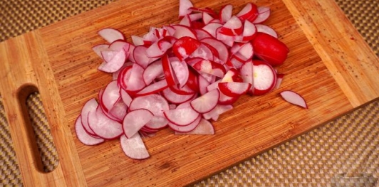 Фото приготовления рецепта: Салат из редиса, огурцов и колбасы - шаг №6