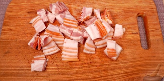 Фото приготовления рецепта: Свинина, тушенная с овощами, беконом и копчёными колбасками (по-дебреценски) - шаг №5